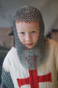 Mark dressed for his photo in front of a painted backdrop of a castle